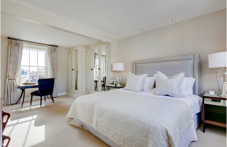 Calm principal bedroom with upholstered bed
