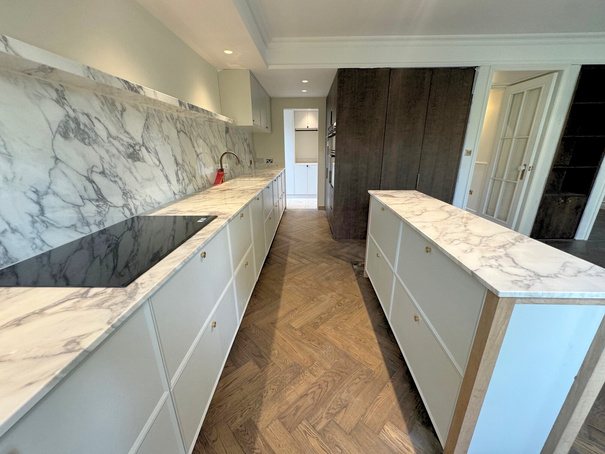 Kitchen with Calacatta marble worktops and herringbone flooring