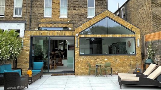 Yellow-brick rear extension with a large glazed gable, Chiswick