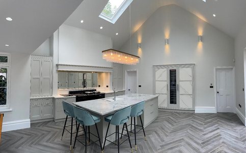 Vaulted kitchen extension with marble island and skylights in Surrey