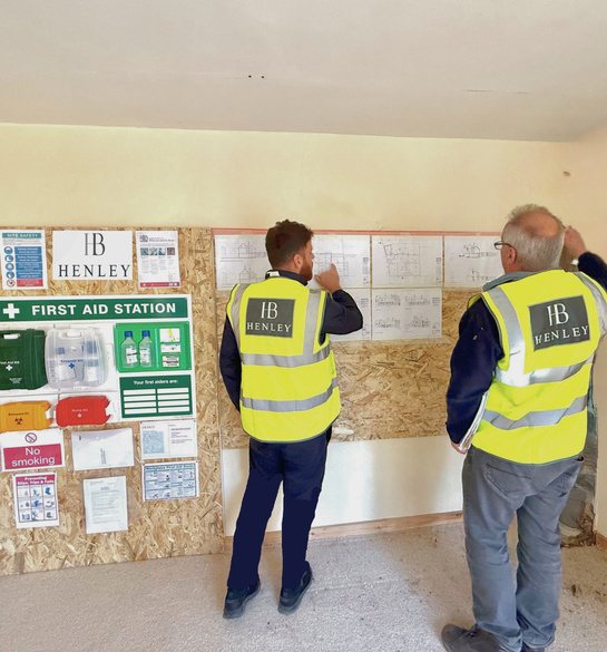 Henley Build project manager and site manager reviewing programme drawings on site