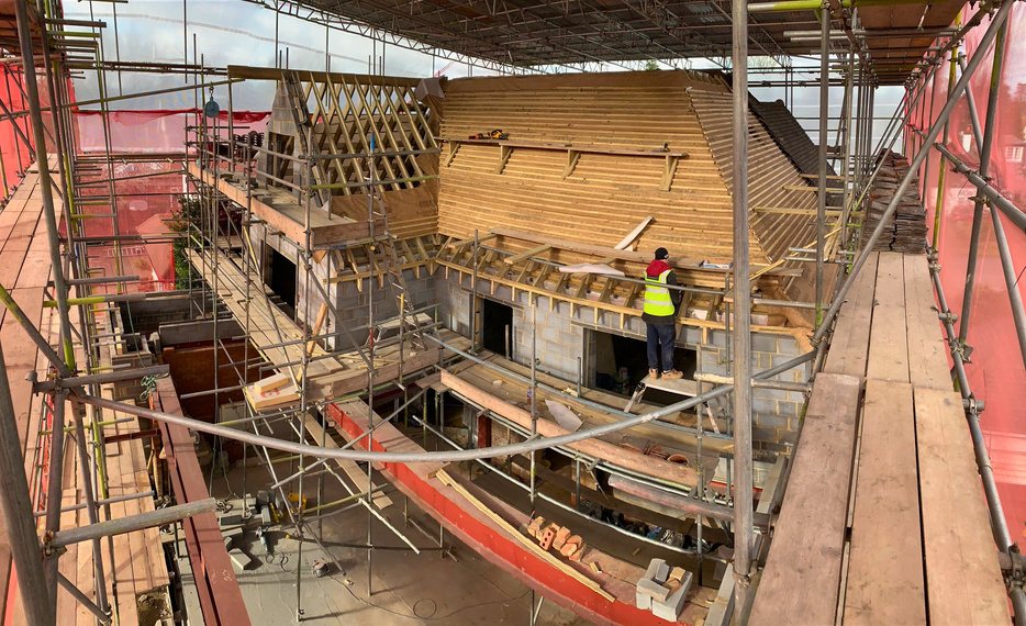Scaffolded new-build house under construction in Surrey